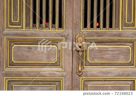 Vintage Chinese style wooden doors in old town, Phukhet, Thailand. 72198023