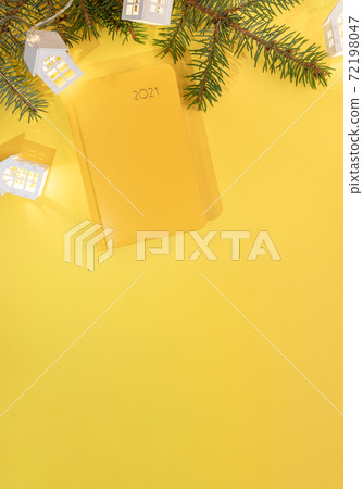 Xmas workspace festive vertical background. Yellow backdrop with notepad on 2021, fir branches, shining Xmas lights white lodges. Planning for next year. Business greeting card. Top view. Copy space. Xmas workspace festive vertical background. Yellow backdrop with notepad on 2021, fir branches, shining Xmas lights white lodges. Planning for next year. Business greeting card. Top view. Copy space. 72198047