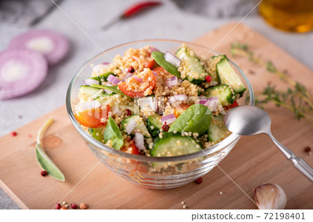 fresh vegetable and quinoa salad in a glass bowl on the table fresh vegetable and quinoa salad in a glass bowl on the table 72198401