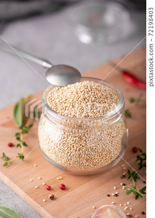 white dry quinoa with spices in a glass jar 72198403