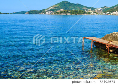 The sea view. Quiet sea with an island. Montenegro 72198673