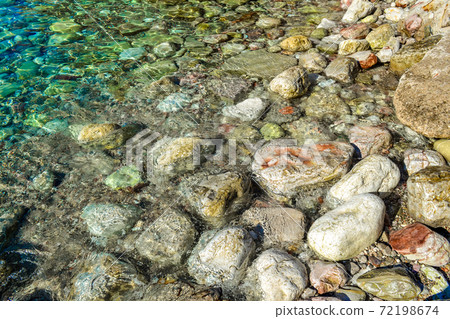 The sea view. Coastal colored stones in the water. Adriatic Sea 72198674