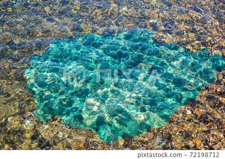 Underwater sea stones, surface with ripples and waves, beautiful pattern transparent clear water Underwater sea stones, surface with ripples and waves, beautiful pattern transparent clear water 72198712