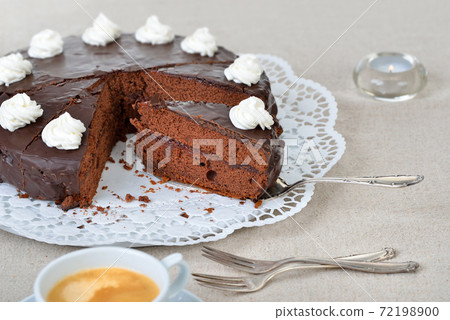 Delicious Viennese cocoa cake with red currant jam and covered with fine dark chocolate and cream Delicious Viennese cocoa cake with red currant jam and covered with fine dark chocolate and cream 72198900