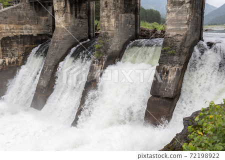 Fast water fall on the hydroelectric power plant 72198922