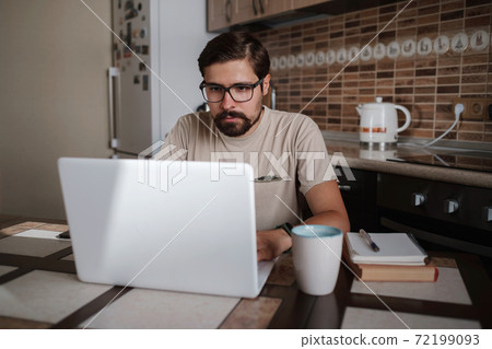 Portrait of handsome young man working in home office, copy space Portrait of handsome young man working in home office, copy space 72199093