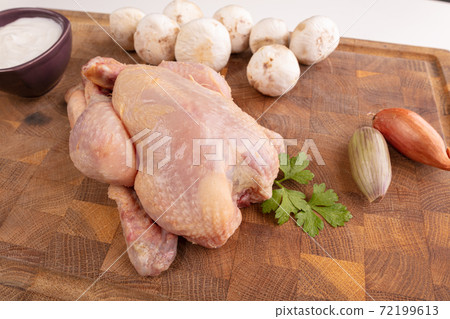 Ingredient for cooking a cockerel on a cutting board Ingredient for cooking a cockerel on a cutting board 72199613