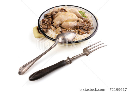 Cockerel with mushrooms and rice in an old enamel dish Cockerel with mushrooms and rice in an old enamel dish 72199617