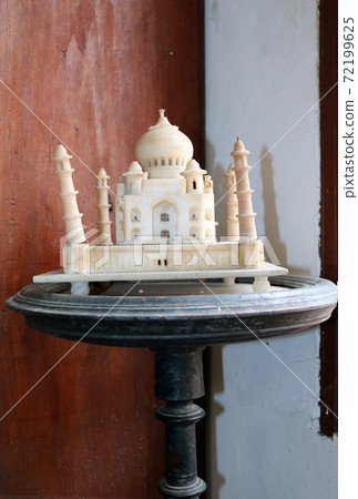 Taj Mahal model made from marble, on the wooden round table. Taj Mahal model made from marble, on the wooden round table. 72199625