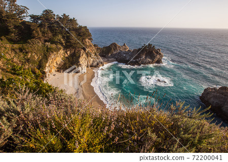 Mcway falls - Pacific coast highway in Big Sur, California, USA in the afternoon with wild flowers. Mcway falls - Pacific coast highway in Big Sur, California, USA in the afternoon with wild flowers. 72200041