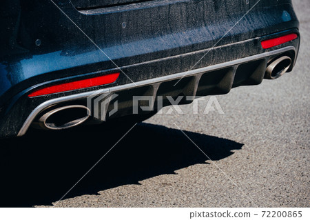 Close up of car exhaust pipe on the street 72200865