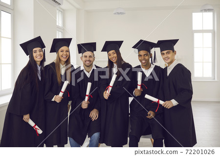 Group of young happy university graduates multiethnic friends with diplomas in hands Group of young happy university graduates multiethnic friends with diplomas in hands 72201026