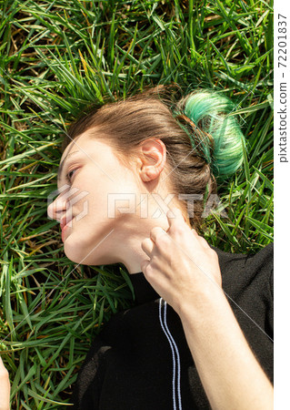 Girl with green hair on grass Girl with green hair on grass 72201837