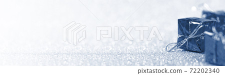 Blue gift boxes on shiny silver background. Christmas and New Year decoration. Long banner 72202340