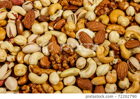Background of mixed nuts (walnuts, pistachio, almond, peanut, cashew, hazelnut). Healthy eating concept Background of mixed nuts (walnuts, pistachio, almond, peanut, cashew, hazelnut). Healthy eating concept 72202790