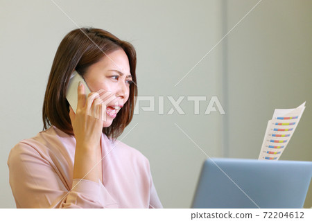 A woman angry on the phone with materials A woman angry on the phone with materials 72204612