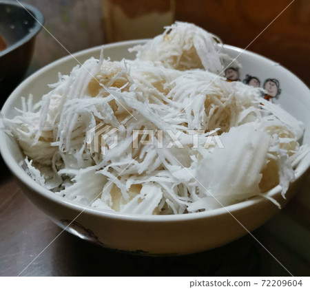 Tom Khao, a kind of Thai dessert. Boiled flour with coconut filling simmered with sugar. 72209604