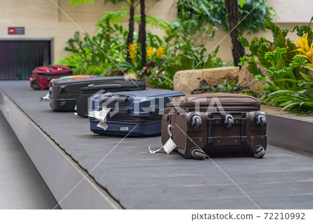 Passenger luggage on conveyor belt at arrival terminal in airport Passenger luggage on conveyor belt at arrival terminal in airport 72210992