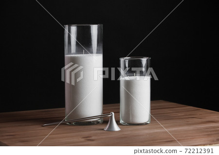 Glass candlestick with a candle isolated on a black background. Glass candlestick with a candle isolated on a black background. 72212391