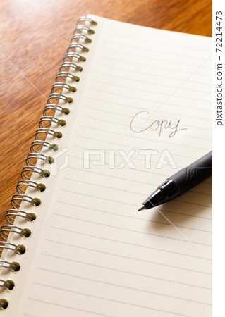 Copywriters who come up with catch phrase ideas with a notebook and pen Copywriters who come up with catch phrase ideas with a notebook and pen 72214473