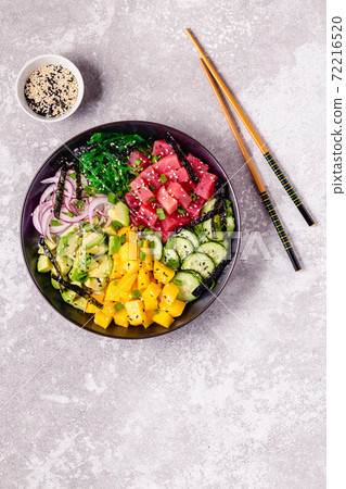 Hawaiian tuna poke bowl with seaweed, avocado, mango, cucumber. 72216520