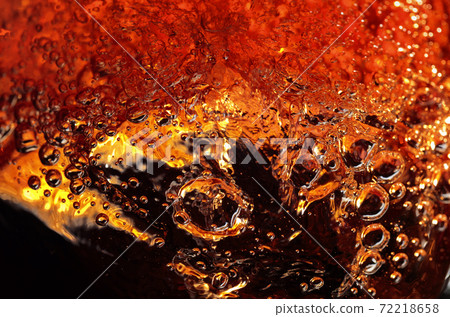 Alcoholic drink on a dark background, abstract splashing. Alcoholic drink on a dark background, abstract splashing. 72218658