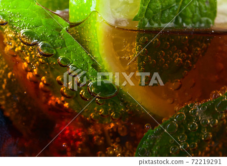 cocktail Cuba libre with lime and peppermint leaves cocktail Cuba libre with lime and peppermint leaves 72219291