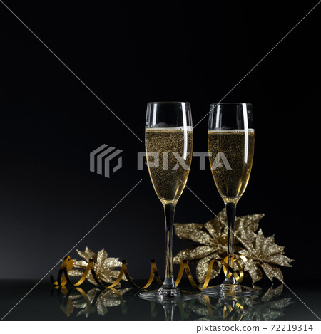 Two glasses of champagne ready to bring New Year on a black background. 72219314