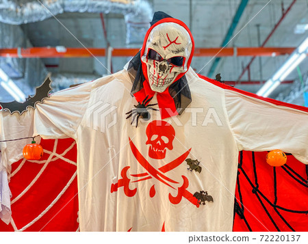 Scary skeleton halloween costume hanging on ceiling  72220137