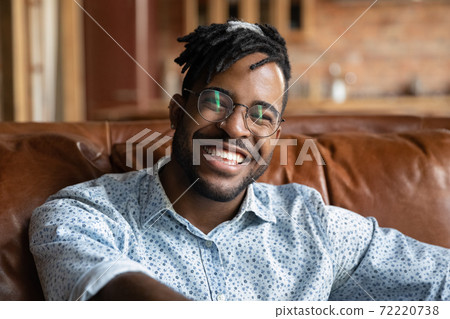 Smiling handsome young african ethnicity man enjoying video call talk. Smiling handsome young african ethnicity man enjoying video call talk. 72220738