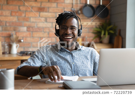 Happy young african american man in headset laughing. Happy young african american man in headset laughing. 72220739