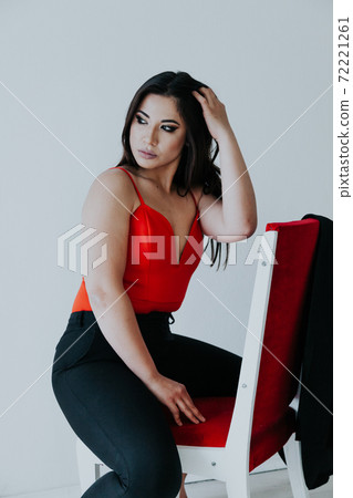Beautiful fashionable oriental brunette woman in black orange dress Beautiful fashionable oriental brunette woman in black orange dress 72221261