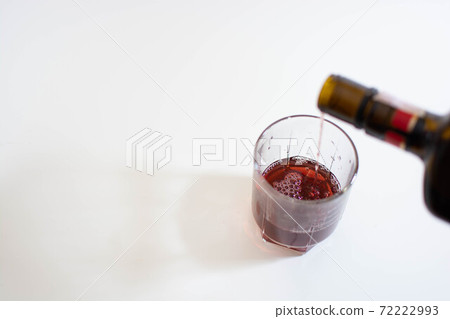 Pouring wine into a glass cup 72222993