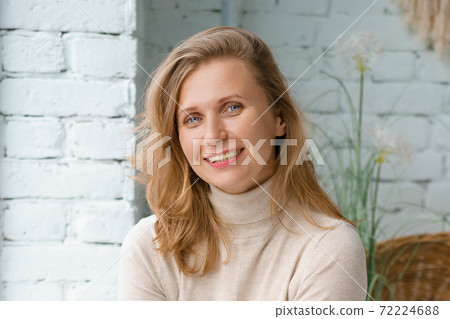 Portrait of a nice woman at the window close up Portrait of a nice woman at the window close up 72224688