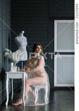 Beautiful young bride in a white lingerie. Last preparations for the wedding. Beautiful young bride in a white lingerie. Last preparations for the wedding. 72225044
