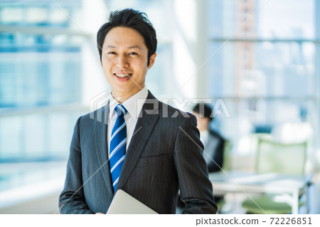 A businessman in his thirties working in a state-of-the-art office 72226851