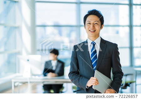 A businessman in his thirties working in a state-of-the-art office A businessman in his thirties working in a state-of-the-art office 72226857