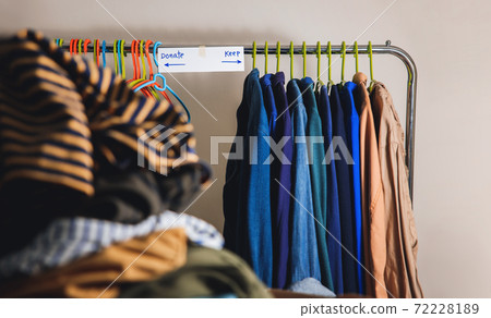 Donation Concept. Separated Used Old Clothes from Wardrobe Rack to Keep and Donate. Focus on Text Donation Concept. Separated Used Old Clothes from Wardrobe Rack to Keep and Donate. Focus on Text 72228189