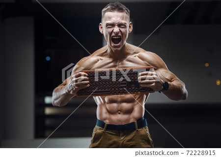 Energy caucasian man with a keyboard screaming 72228915