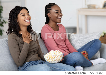 African american women watching comedy at home 72229365