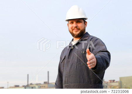 Portrait of male foreman with outstetched hands standing in construction site background. Portrait of male foreman with outstetched hands standing in construction site background. 72231006
