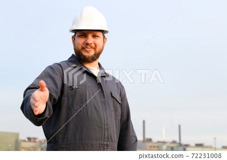Portrait of european foreman with outstetched hands standing in construction site background. Portrait of european foreman with outstetched hands standing in construction site background. 72231008