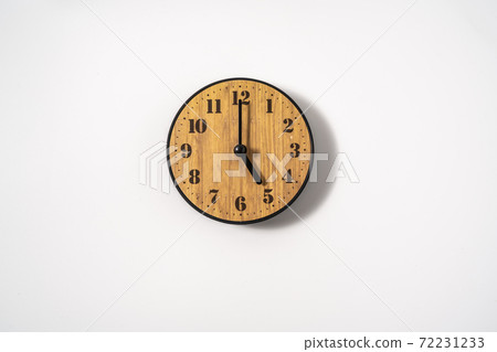 wood office wall clock with white dial on white background. wall clock on white background, top view. wood office wall clock with white dial on white background. wall clock on white background, top view. 72231233