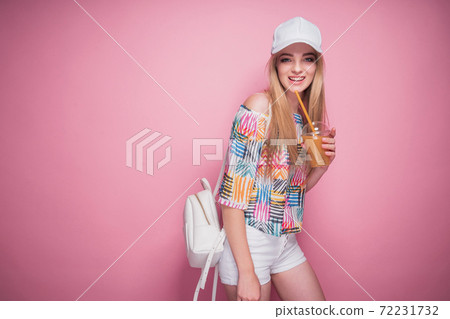 Stylish young woman with drink in summertime 72231732