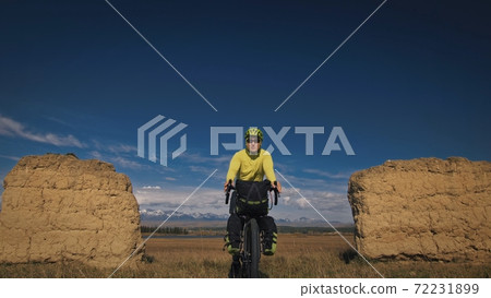 The man travel on mixed terrain cycle touring with bikepacking. The traveler journey with bicycle bags. Sport tourism bikepacking. 72231899