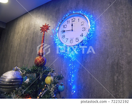 Clock and christmas tree, balls, toys. Timelapse New Year. The clock is hanging on the wall. Time on the clock is 23.45 to 00.00. Clock and christmas tree, balls, toys. Timelapse New Year. The clock is hanging on the wall. Time on the clock is 23.45 to 00.00. 72232192