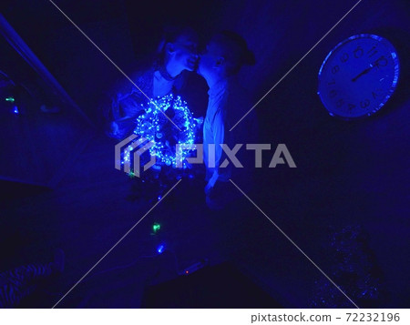 The family fast and fanny decorates the Christmas tree. Top view. Time on the clock is 23.45 on wall. Happy dad, mom, daughter are run around tree. The family fast and fanny decorates the Christmas tree. Top view. Time on the clock is 23.45 on wall. Happy dad, mom, daughter are run around tree. 72232196