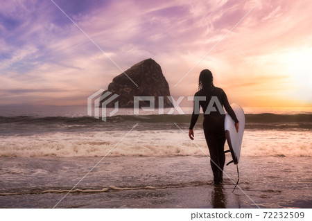 Adventurous Girl with a Surf Board is going surfing 72232509