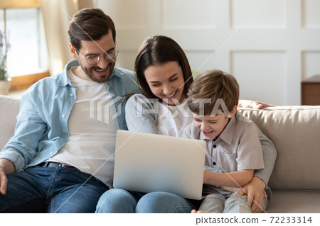 Overjoyed young family with small son have fun using laptop Overjoyed young family with small son have fun using laptop 72233314