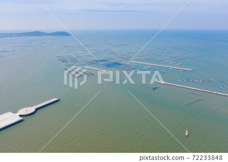 Aerial view of aquaculture nets for fish farm in a lake in Sri Racha, Chonburi, Thailand. tropical beach, Andaman sea, bay island. Top view. Aerial view of aquaculture nets for fish farm in a lake in Sri Racha, Chonburi, Thailand. tropical beach, Andaman sea, bay island. Top view. 72233848
